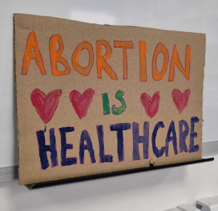 Cardboard protest sign that reads Abortion is Healthcare